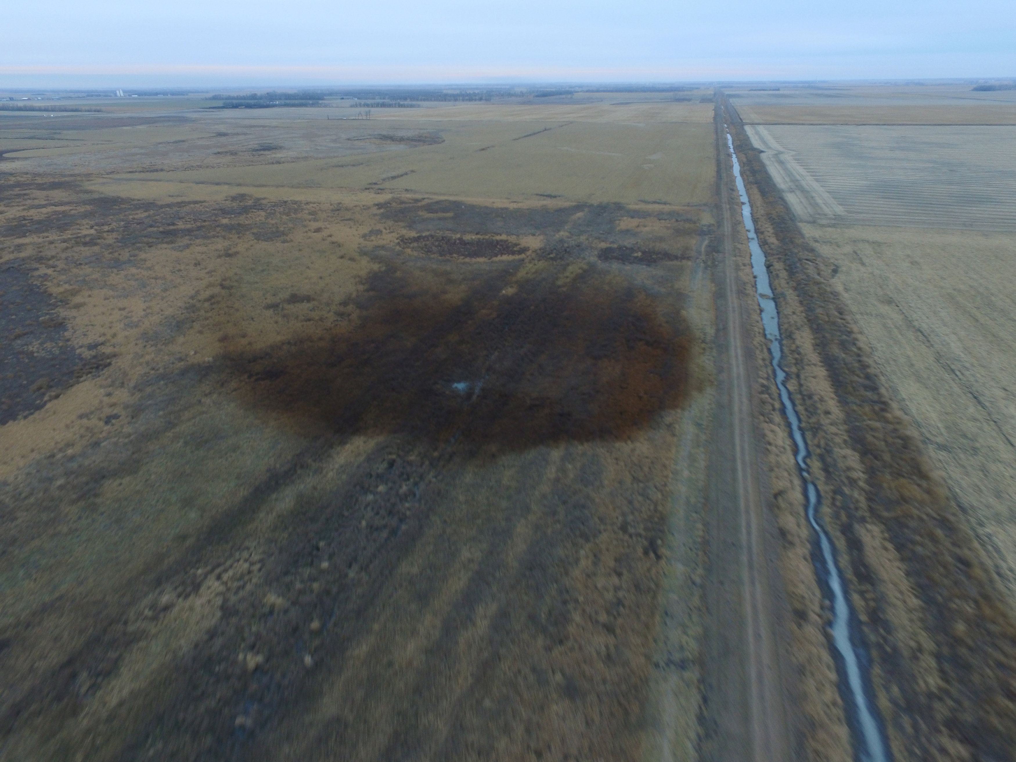 An aerial view shows the darkened ground of an oil spill which shut down the Keystone pipeline between Canada and the United States, located in an agricultural area near Amherst, South Dakota, U.S., in this photo provided November 18, 2017.