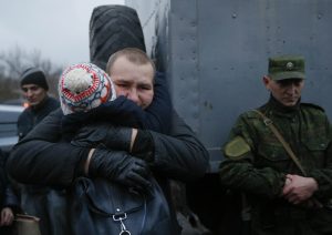 A prisoner (back) of war (POW) from the Ukrainian armed forces is embraced during the exchange of captives in Horlivka in Donetsk region, Ukraine December 27, 2017.