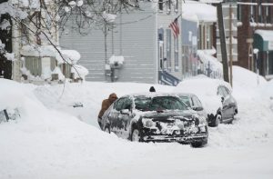People help dig out a car from a parking spot after two days of record-breaking snowfall in Erie, Pennsylvania, U.S., December 27, 2017.