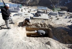 People dig graves for the victims of yesterday's suicide attack at Shi'ite cultural centre in Kabul, Afghanistan December 29, 2017.