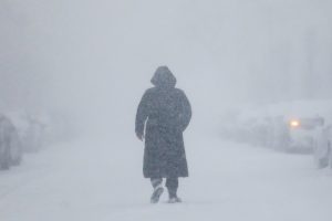 A woman walks down the street during a blizzard in Long Beach, New York, U.S. January 4, 2018.