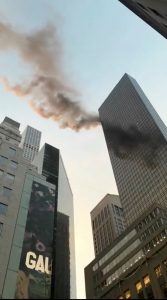 A smoke is seen rising from the roof of Trump Tower.