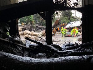 Emergency personnel search through debris and damaged homes after a mudslide in Montecito, California, U.S. in this photo provided by the Santa Barbara County Fire Department, January 9, 2018.