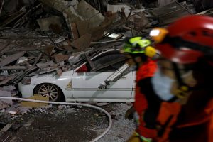 Rescue personnel search a collapses building after an earthquake hit Hualien, Taiwan February 7, 2018.