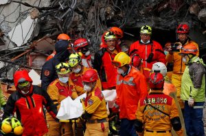 A body of employee of collapsed Marshal Hotel is carried by a rescue personnel after an earthquake hit Hualien, Taiwan February 7, 2018.