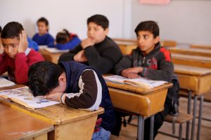 Hussein al-Khalaf, 13, reacts as he sits in a classroom at a school in Sahnaya, near Damascus Syria February 1, 2018. Picture taken February 1, 2018.