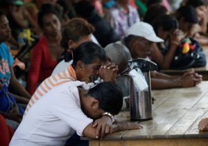 Venezuelans pray as they gather at a dining facility organised by Caritas and the Catholic church, in Cucuta, Colombia February 21, 2018. REUTERS/Carlos Eduardo Ramirez