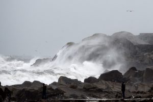 People stand and watch rough seas as Storm Emma makes landfall in Dublin, Ireland March 1, 2018. REUTERS/Clodagh Kilcoyne