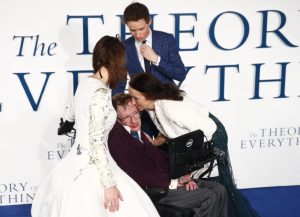 Jane Wilde Hawking kisses her ex-husband Stephen Hawking as she arrives at the UK premiere of the film "The Theory of Everything" which is based around Stephen Hawking's life, at a cinema in central London December 9, 2014. Actors Eddie Redmayne and Felicity Jones, who play Stephen and Jane in the film, look on. REUTERS/Andrew Winning