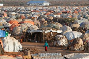 A woman walks past thw makeshift shelters at the new Kabasa Internally displaced camp in the northern Somali town of Dollow, Somalia, February 25, 2018. Picture taken February 25, 2018. REUTERS/Baz Ratner