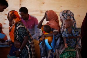 Somali women stand in line to receive infants food aid in the northern Somali town of Dollow, Somalia, February 26, 2018. Picture taken February 26, 2018.REUTERS/Baz Ratner