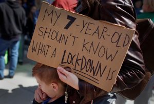 A protestor holds a sign during a "March For Our Lives" demonstration demanding gun control in Sacramento, California, U.S. March 24, 2018. REUTERS/Bob Strong
