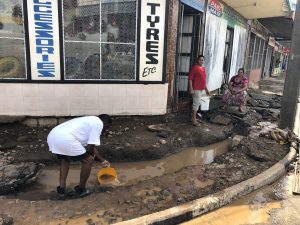 FILE PHOTO - A man collects water, after flooding from Tropical Cyclone Josie in Ba, Fiji April 1, 2018 in this image obtained from social media. Naziah Ali via REUTERS