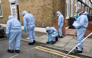 Forensic investigators examine the pavement and carriageway on Chalgrove Road, where a teenage girl was murdered, in Tottenham, Britain, April 3, 2018. REUTERS/Toby Melville