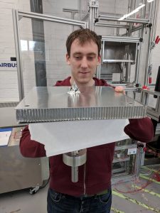 Alastair Wayman, Advanced Projects Engineer at Airbus Space, examines the tip of a large harpoon after a test firing into a simulated section of satellite as part of an European Space Agency project in Stevenage, Britain, April 4, 2018. Picture taken April 4, 2018. REUTERS/Stuart McDill