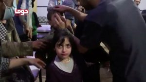 A girl looks on following alleged chemical weapons attack, in what is said to be Douma, Syria in this still image from video obtained by Reuters on April 8, 2018. White Helmets/Reuters TV via REUTERS