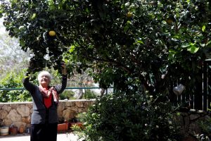 Holocaust survivor Betty Kazin Rosenbaum, 76, stands under a tree in her garden in Zichron Yaakov, Israel, April 10, 2018. REUTERS/Nir Elias