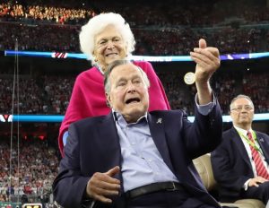 FILE PHOTO - Former U.S. President George H.W. Bush participates in the coin toss ahead of the start of Super Bowl LI between the New England Patriots and the Atlanta Falcons as former first lady Barbara Bush looks on in Houston , Texas, U.S., February 5, 2017. REUTERS/Adrees La