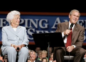 FILE PHOTO: U.S. President George W. Bush (R) jokes with his mother, Barbara Bush, while speaking about Medicare at the Boisfeuillet Jones Atlanta Civic Center in Atlanta, Georgia, July 22, 2005. REUTERS/Larry Downing/File Photo