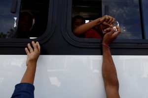 A group of Central American migrants, moving in a caravan through Mexico, ask for money to get on a microbus to the office of Mexico's National Institute of Migration to start the legal process and get temporary residence status for humanitarian reasons, in Hermosillo, Sonora state, Mexico April 24, 2018. REUTERS/Edgard Garrido