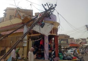 A damaged electric pole is pictured in a market after strong winds and dust storm in Alwar, in the western state of Rajasthan, India May 3, 2018. REUTERS/Stringer