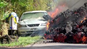 Lava engulfs a Ford Mustang in Puna, Hawaii, U.S., May 6, 2018 in this still image obtained from social media video. WXCHASING via REUTERS