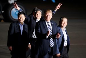 The three Americans formerly held hostage in North Korea gesture next to U.S.President Donald Trump, upon their arrival at Joint Base Andrews, Maryland, U.S., May 10, 2018. REUTERS/Jim Bourg