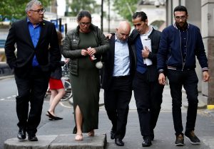 Marcio and Andreia Gomes, parents of Logan Gomes, are comforted as they arrive for a commemoration hearing at the opening of the inquiry into the Grenfell Tower disaster, in London, Britain May 21, 2018. REUTERS/Henry Nicholls