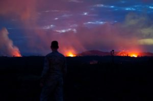 A Hawaii Air National Guard Airman observes three lava fissures at Leilani Estates and Lanipuna Gardens subdivisions in Pahoa, Hawaii, U.S., May 15, 2018. Courtesy John Linzmeier/U.S. Air National Guard/Handout via REUTERS