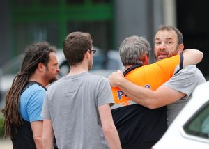 A man is being consoled by a police officer on the scene of a shooting in Liege, Belgium, May 29, 2018. REUTERS/Francois Lenoir