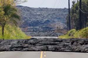 Lava covers a road in Pahoa during ongoing eruptions of the Kilauea Volcano in Hawaii, U.S., June 3, 2018. REUTERS/Terray Sylvester