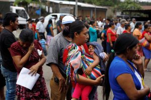 Residents wait in line to receive aid at an area affected by the eruption of Fuego volcano at the village of Sangre de Cristo in Chimaltenango, Guatemala, June 7, 2018. REUTERS/Jose Cabezas