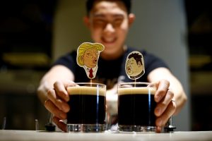 A bartender presents a pair of Donald Trump and Kim Jong Un cocktails called The Bromance at Hopheads Craft Beer Bar and Bistro in Singapore June 8, 2018. REUTERS/Feline Lim