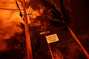Lava illuminates a sign in Leilani Estates during ongoing eruptions of the Kilauea Volcano in Hawaii, U.S., June 9, 2018. REUTERS/Terray Sylvester