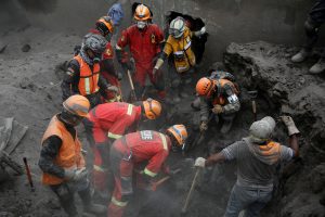 Rescue workers continue to search for human remains, after the eruption of the Fuego volcano, in San Miguel Los Lotes in Escuintla, Guatemala June 14, 2018. REUTERS/Luis Echeverria