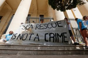 Crew members of NGO Sea-Watch protest outside the Courts of Justice during the arraignment of Claus-Peter Reisch, the captain of the charity ship MV Lifeline in Valletta, Malta July 2, 2018. REUTERS/Darrin Zammit Lupi