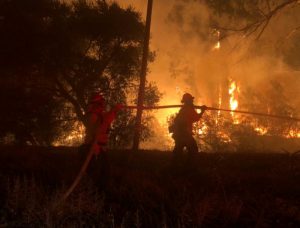 Firefighters work at the site of a wildfire in Goleta, California, U.S., July 6, 2018 in this image obtained on social media. Mike Eliason/Santa Barbara County Fire/via REUTERS