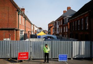 FILE PHOTO: A police officer stands in front of screening erected behind John Baker House, after it was confirmed that two people had been poisoned with the nerve-agent Novichok, in Amesbury, Britain, July 5, 2018. REUTERS/Henry Nicholls/File Photo