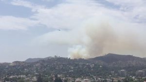 Smoke rises from a brush fire near the Giffith Observatory in Los Angeles, United States, in this still image taken from a July 10, 2018 video footage by Elizabeth West obtained from social media. Elizabeth West/Social Media/via REUTERS