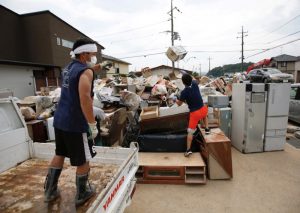 Local residents try to clear debris at a flood affected area in Mabi town in Kurashiki, Okayama Prefecture, Japan, July 12, 2018. REUTERS/Issei Kato