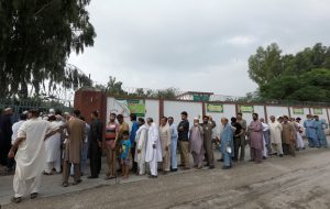 People stand in a line as they wait for a polling station to open, during general election in Rawalpindi, Pakistan July 25, 2018. REUTERS/Faisal Mahmood