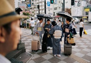 Kimono-clad women using sun umbrellas pause on a street during a heatwave in Tokyo, Japan July 25, 2018. REUTERS/Issei Kato