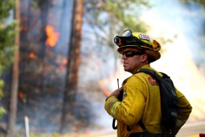 Jul 30, 2018; Redding, CA, USA; Todd Abercrombie, of Cal Fire watches the fire behavior as firefighters monitor fire movement as it crosses Highway 299 just west of Buckhorn Summit near the Trinity County line. Firefighters made progress on the fire which is now at 20 percent containment. Kelly Jordan via USA TODAY NETWORK