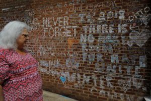 Susan Bro, mother of Heather Heyer, who was killed during the August 2018 white nationalist rally in Charlottesville, looks at the memorial and writings at the site where her daughter was killed in Charlottesville, Virginia, U.S., July 31, 2018. Picture taken July 31, 2018. REUTERS/Brian Snyder