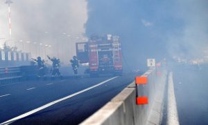 Firefighters work on the motorway after an accident caused a large explosion and fire at Borgo Panigale, on the outskirts of Bologna, Italy, August 6, 2018. REUTERS/Stringer