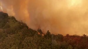 Aerial view of Trabuco Canyon as a tanker aircraft dumps load onto Holy Fire, Near Santiago Peak, California, U.S., August 6, 2018 in this still image taken from a video obtained from social media. TWITTER / @ZULUJUMPER/via REUTERS