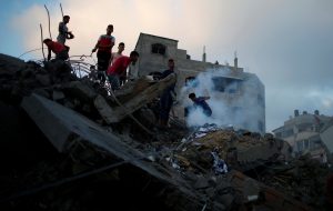 Palestinians gather on the remains of a building after it was bombed by an Israeli aircraft, in Gaza City August 9, 2018. REUTERS/Mohammed Salem