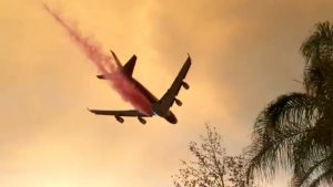 A plane dumps fire retardant over the Holy Fire as it spreads in Lake Elsinore, California, the U.S. August 8, 2018 in this still image taken from a video obtained from social media. Lake Elsinore City Hall/via REUTERS