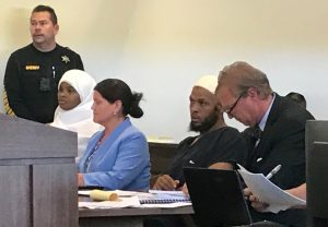 Defense attorney Thomas Clark (R) sits next to his client, defendant Siraj Ibn Wahhaj, defense attorney Marie Legrand Miller (2nd L) and her client Hujrah Wahhaj (L) during a hearing on charges of child abuse in which they were granted bail in Taos County, New Mexico, U.S. August 12, 2018. REUTERS/Andrew Hay