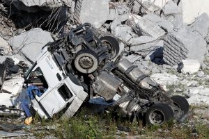 A crushed truck is seen at the collapsed Morandi Bridge site in the port city of Genoa, Italy August 14, 2018. REUTERS/Stefano Rellandini